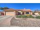 Charming single-story home featuring a well-manicured front yard and attached two-car garage at 13214 S 39Th St, Phoenix, AZ 85044