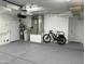 Epoxy floor in clean garage area with water heater and bike at 13214 S 39Th St, Phoenix, AZ 85044