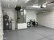 Well-lit garage features epoxy flooring, water heater, and a bicycle parked inside at 13214 S 39Th St, Phoenix, AZ 85044