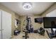 Home gym with an elliptical machine, weights, weight machine, and television for effective workouts at 13214 S 39Th St, Phoenix, AZ 85044