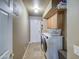 Well-lit laundry room with modern washer and dryer and storage at 13214 S 39Th St, Phoenix, AZ 85044