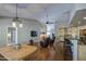 Open-concept living area with hardwood floors, vaulted ceiling, bar seating, and seamless access to kitchen at 13214 S 39Th St, Phoenix, AZ 85044