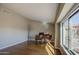 Inviting living room features gleaming hardwood floors, neutral tones, and a large window with natural light at 13214 S 39Th St, Phoenix, AZ 85044