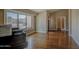Bright living room features gleaming hardwood floors, neutral tones, and a large window with natural light at 13214 S 39Th St, Phoenix, AZ 85044