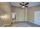Large main bedroom features private access to the bathroom, ceiling fan and tiled floor at 13214 S 39Th St, Phoenix, AZ 85044