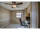Office space featuring built-in cabinets, a desk, a ceiling fan, and a window for natural light at 13214 S 39Th St, Phoenix, AZ 85044