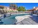 Sparkling backyard pool with unique patio design, surrounded by attractive landscaping and a safety fence at 13214 S 39Th St, Phoenix, AZ 85044