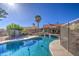 Sparkling pool with surrounding fence and a covered patio seating area at 13214 S 39Th St, Phoenix, AZ 85044