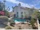 This backyard boasts a sparkling private pool, mature trees and plants, and a covered patio, perfect for outdoor living at 13517 N 102Nd Pl, Scottsdale, AZ 85260