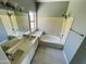 Bathroom featuring a double sink vanity and separate tub and shower at 13517 N 102Nd Pl, Scottsdale, AZ 85260