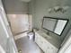 Bathroom with a shower-tub combo, toilet, single sink vanity, and light fixture at 13517 N 102Nd Pl, Scottsdale, AZ 85260