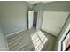 Empty bedroom featuring laminated wood-look floors, neutral paint and a closet at 13517 N 102Nd Pl, Scottsdale, AZ 85260