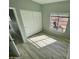 Bedroom with a window, large closet doors, and wood look laminate flooring at 13517 N 102Nd Pl, Scottsdale, AZ 85260