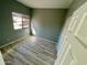 Bedroom featuring laminate flooring, neutral walls, a window, and a closet at 13517 N 102Nd Pl, Scottsdale, AZ 85260