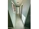 Bright hallway featuring light gray walls, white trim, wood-look floors, and natural light from a window at 13517 N 102Nd Pl, Scottsdale, AZ 85260