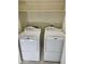 Laundry room with two white, front load washing machines at 13517 N 102Nd Pl, Scottsdale, AZ 85260