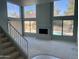 Bright living room with fireplace and large windows, offering picturesque views of the pool and backyard at 13517 N 102Nd Pl, Scottsdale, AZ 85260