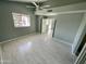 Bright main bedroom with a ceiling fan, window, and neutral walls and flooring at 13517 N 102Nd Pl, Scottsdale, AZ 85260