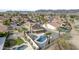 An aerial view showcases a home with a freeform pool, extended covered patio and fenced yard at 15039 S 28Th St, Phoenix, AZ 85048