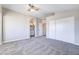 Bedroom featuring neutral carpet and paint, closet, archway to the bathroom, plus ceiling fan at 15039 S 28Th St, Phoenix, AZ 85048
