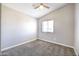 Cozy bedroom with carpeted floors, ceiling fan, neutral colored walls, and window letting in natural light at 15039 S 28Th St, Phoenix, AZ 85048