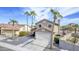 Two-story home featuring palm trees, desert landscaping, a two-car garage, and a red-tiled roof in a sunny neighborhood at 15039 S 28Th St, Phoenix, AZ 85048