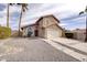 Home with a two-car garage, concrete driveway, palm trees and neutral colored stucco exterior at 15039 S 28Th St, Phoenix, AZ 85048