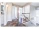 Bright hallway boasts tile flooring, white walls, and doorways leading to various rooms within the home at 15039 S 28Th St, Phoenix, AZ 85048