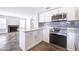 Modern kitchen with white cabinets, stainless steel appliances, marble countertops, and tiled backsplash at 15039 S 28Th St, Phoenix, AZ 85048