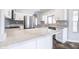 Bright kitchen with large marble countertop island, modern appliances, and stainless steel dishwasher at 15039 S 28Th St, Phoenix, AZ 85048