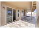 Covered outdoor patio with stone tile flooring, providing a comfortable and inviting space for relaxation and entertaining at 15039 S 28Th St, Phoenix, AZ 85048