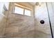 Elegant shower with tile surround, dark hardware, window to let light in, plus tiled shower niche at 15039 S 28Th St, Phoenix, AZ 85048