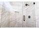 Large walk in shower featuring marble style tile and black hardware, plus built in shower niche at 15039 S 28Th St, Phoenix, AZ 85048