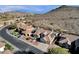 Stunning aerial view captures a luxury home with desert landscape, pool, and neighboring properties at 1635 E Silverwood Dr, Phoenix, AZ 85048