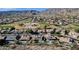 High angle shot of a community featuring homes with pools, golf course, and desert scenery at 1635 E Silverwood Dr, Phoenix, AZ 85048