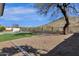 Spacious backyard features a pool, hot tub, artificial turf, and desert landscaping providing an oasis at 1635 E Silverwood Dr, Phoenix, AZ 85048