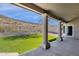 Expansive backyard with covered patio, turf, and privacy fence at 1635 E Silverwood Dr, Phoenix, AZ 85048