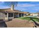 Backyard with a covered patio, gravel landscaping, and artificial turf, perfect for outdoor living at 1635 E Silverwood Dr, Phoenix, AZ 85048