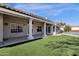 Stunning backyard featuring columns, turf, and a built-in pool at 1635 E Silverwood Dr, Phoenix, AZ 85048