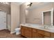 Bathroom featuring dual sinks, a large mirror, and a toilet at 1635 E Silverwood Dr, Phoenix, AZ 85048