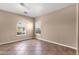 This bedroom has neutral walls, tiled floors, and two windows at 1635 E Silverwood Dr, Phoenix, AZ 85048