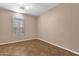 This bedroom has neutral walls, tiled floors and one window at 1635 E Silverwood Dr, Phoenix, AZ 85048