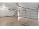 This is a large and empty 3-car garage at 1635 E Silverwood Dr, Phoenix, AZ 85048