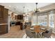 Eat-in kitchen features granite counters, an island, breakfast bar seating, dark wood cabinets, and backyard pool views at 1635 E Silverwood Dr, Phoenix, AZ 85048