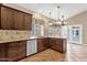 Bright kitchen with stainless dishwasher, granite countertops, and views through the sunny windows at 1635 E Silverwood Dr, Phoenix, AZ 85048