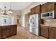 Open-concept kitchen with stainless steel refrigerator, granite counters, and backyard access at 1635 E Silverwood Dr, Phoenix, AZ 85048