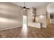 Open-concept living room featuring tiled flooring, a ceiling fan, and bar area for seamless entertaining at 1635 E Silverwood Dr, Phoenix, AZ 85048