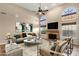 Bright and airy living room with a fireplace, high ceilings, modern furniture, and a ceiling fan at 1635 E Silverwood Dr, Phoenix, AZ 85048
