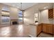 Open floor plan with a fireplace, large windows, and a convenient wet bar area at 1635 E Silverwood Dr, Phoenix, AZ 85048