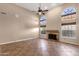 Vaulted ceiling living room boasting natural light, a ceiling fan, and a cozy fireplace at 1635 E Silverwood Dr, Phoenix, AZ 85048